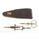 Two pairs of scissors and a leather scissor case, comprising a pair in the form of a dagger in