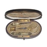 A French etui in Boulle style case, circa 1840, the oval ebonised case with cut brass inlay to