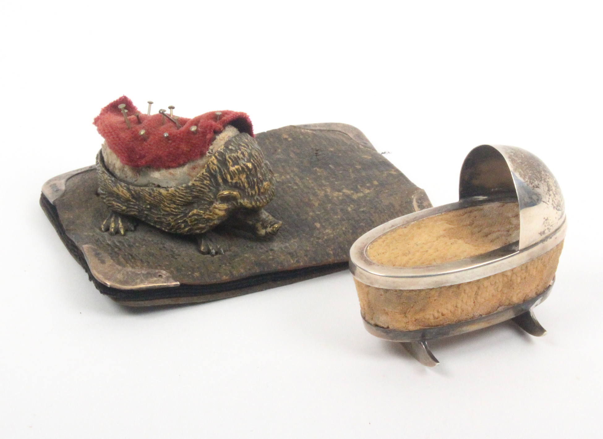 A silver novelty pin cushion and a pen wiper, the pin cushion in the form of a rocking cradle,