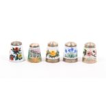 Five silver and enamel thimbles by James Swann and Son comprising a floral example inscribed '