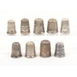 Nine attractive British silver thimbles including an 'Election', a 'Royal Spa' and a leather cased