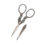 A pair of silver mounted scissors with sheath, oval section tapering steel blades, the arms as