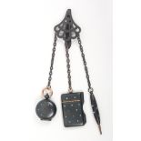 A late 19th Century blued steel chatelaine the pierced clip to three chains fitted sovereign case,