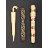 Three needle cases comprising a turned bone cylinder example brightly painted with flowers and