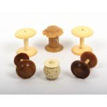 Six reel holders comprising a 19th Century pair in ivory with fancy tops, a pair in coquilla with