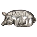 An unusual silver novelty pin cushion in the form of a pig lying on its side with one ear raised and