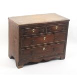 A 19th Century 'apprentice' mahogany chest of two short and two long drawers each with shield from