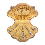 An early 20th Century continental sewing companion, the case of scallop outline covered in paper
