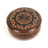 A well turned rosewood circular Tunbridge ware box, the over hanging lid in geometric stickware, 6cm