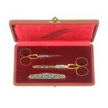 A Swedish cased set of two pairs of graduated scissors and a folding two blade knife, the
