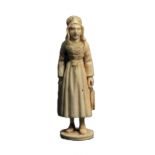 A 19th Century carved Dieppe ivory standing needle case, as a fisher woman in traditional costume,