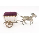 A French pin cushion and cart, the purple velvet pin cushion over a milk glass pannier on gilt metal