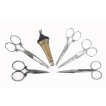 Five pairs of early 19th century steel scissors together with a brass scissor sheath, largest 10.5cm