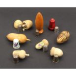 Eight thimble cases, comprising five bone and ivory examples four as acorns, one stained red, an egg