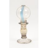 A 19th Cenntury blown glass lace makers lamp, the bulbous body on baluster stem to a spreading foot,