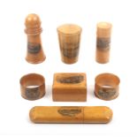 Mauchline ware - seven pieces comprising a spectacle case (Esplanade, Bognor) 15.5cm, a cylinder