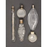 Five glass scent bottles comprising a Georgian cut glass example of oval pointed form with silver