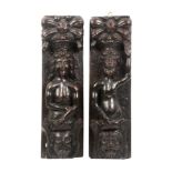 A pair of 18th Century carved oak caryatids, one of a bearded naked man over a lion mask on