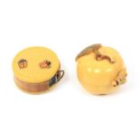 Two novelty celluloid tape measures, comprising an apple with leaf and stalk, the printed tape in