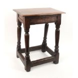 A 17th Century oak joint stool, the railed frieze on block turned legs united by rail stretchers,