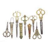 Six pairs of scissors and a sheath comprising four pairs of brass handled desk scissors two with