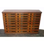 A good late 19th Century haberdashery cabinet of twenty four drawers, each with a numerical label,