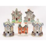Five Staffordshire pottery cottages including a pair in the form of pastille burners, 16cm high