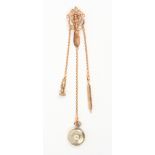 A late Victorian chatelaine, the gilt metal pierced hook mount with three gold chains to a seal,
