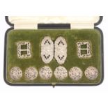 Buttons and Buckles, a cased silver set comprising six pierced scroll decorated buttons, a pair of