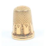 An American gold thimble, unmarked, engraved panelled frieze marked '8'