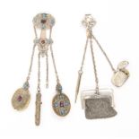 Two late 19th century chatelaines comprising a white metal example with silver vesta, silver purse