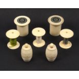 Reels and cotton barrels, comprising a set of three ivory reels with roundel turned tops, 3.5cm.,