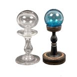 Two 19th century glass lace makers lamps comprising a blue glass ball on turned wooden pedestal