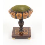 An attractive Tunbridge ware pedestal pin cushion, the square base raised on four bun feet and