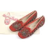 A pair of embroidered slippers 18th /19th Century , in red felt lined in kid leather edged with