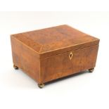 A Georgian burr yew wood sewing box, of sarcophagal form with boxwood strung corners, the interior
