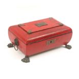 A Regency red leather sewing box of bombe form, raised on brass lion paw feet with brass lion mask