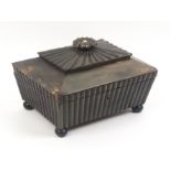 An early 19th Century Anglo Indian horn sewing box, of sarcophagal form, the base section reeded,