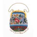 An attractive early Victorian beadwork bag each side with colourful flowers over a garden scene with