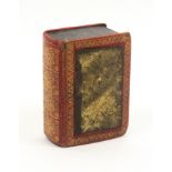 A Georgian sewing companion for a child in the form of a gilt tooled red leather book, the