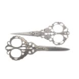 Two pairs of 19th century decorative steel scissors both with pierced and engraved arms as birds