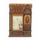 An unusual Sorrento ware picture frame, the rectangular glazed aperture within inlaid panels of
