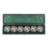 Buttons - a cased set of six, silver Art Nouveau style buttons decorated with a pierced design of