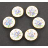 Buttons - a set of six 19th Century porcelain buttons, each painted with flowers in tones of blue,