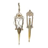 Two chatelaine fittings comprising a pair of steel scissors in sheath on chains and pierced floral