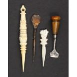 Three stilettos and a seam knife comprising a well carved reversible ivory stiletto, 10.5cm, a