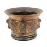 A copper bronze mortar, probably 17th Century, the body with four decorated circular panels