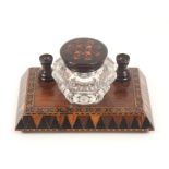 A Tunbridge ware rosewood ink stand, the rectangular base on four bun feet with a canted border in