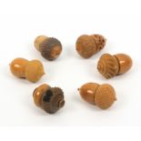 Six vegetable ivory thimble cases, all of acorn form, five with thimbles, largest 5.5cm (6)