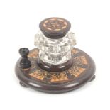 A Tunbridge ware ink stand, the circular base on three bun feet with an octagonal band of mosaic and
